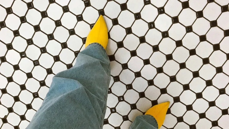 Artistic lifestyle photo of a founder taking a step forward on a tiled floor, representing founder visibility business pivots.